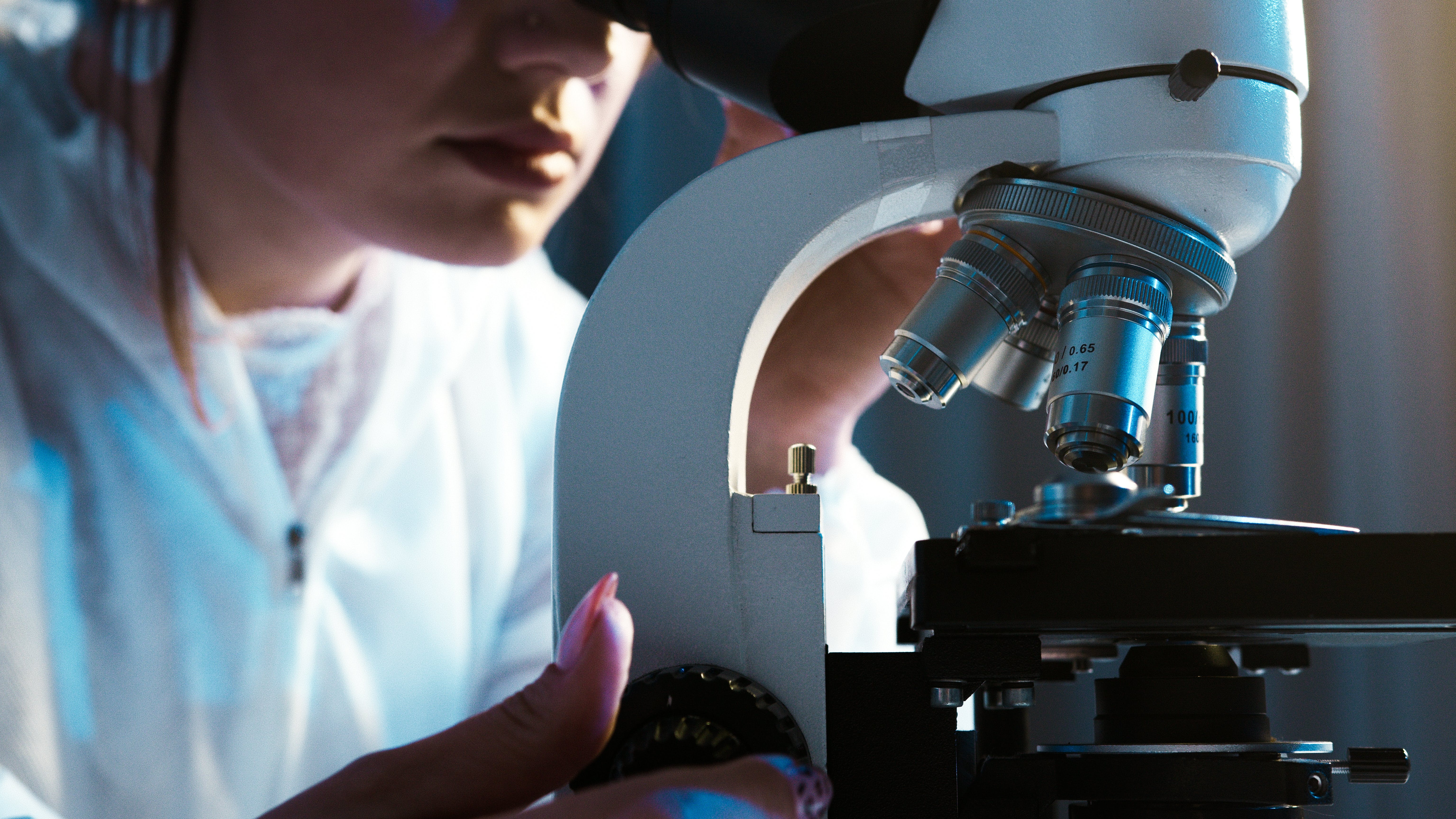 student using microscope