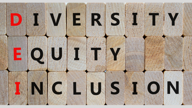 wood blocks with words "diversity, equity, inclusion" written on them