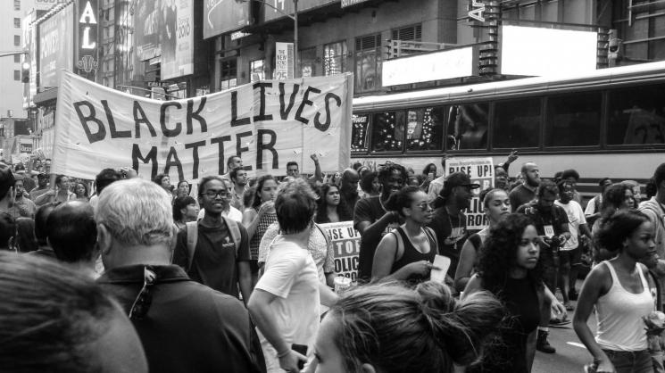 protest with black lives matter poster