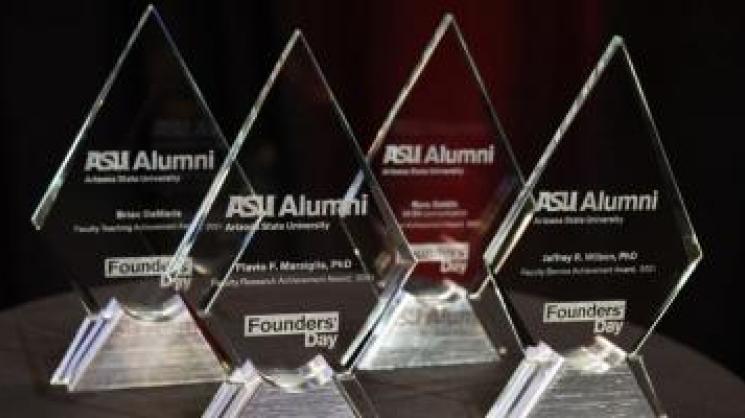 black background with four trophies labeled "ASU Alumni"