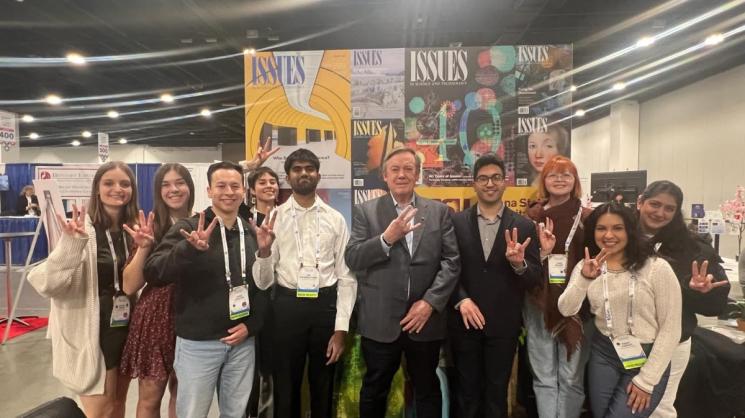 graduate and undergraduate students from ASU take picture with Michael Crow at AAAS